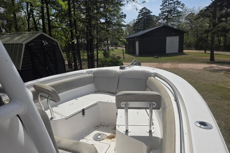 Slide: The Image of 2019 Sea Fox 226 Commander boat with seating, parked near trees and a shed. - 6