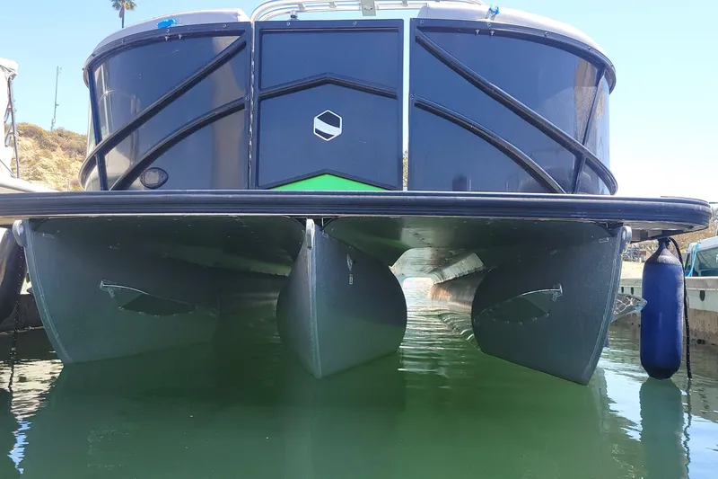 Slide: The Image of 2023 South Bay 525UL AR pontoon boat docked on calm water. - 10
