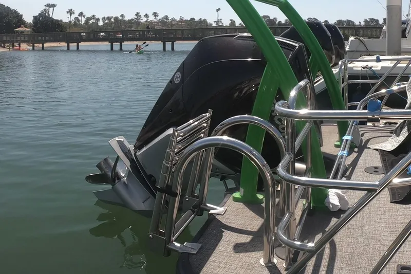 Slide: The Image of 2023 South Bay 525UL AR boat with outboard motor on a sunny day by the water. - 11