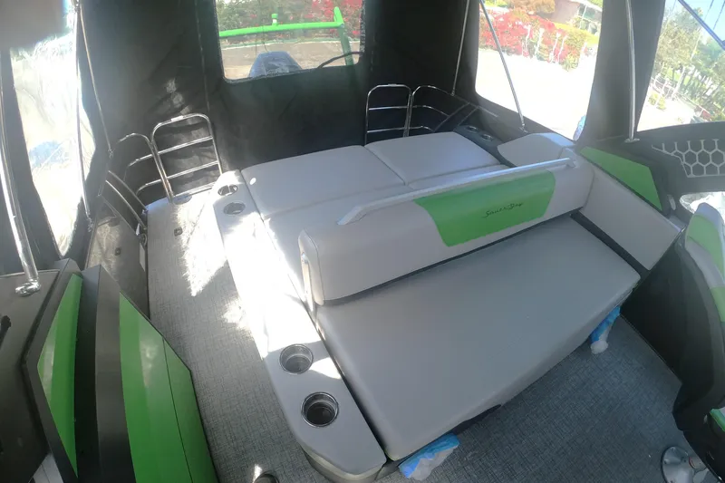 Slide: The Image of 2023 South Bay 525UL AR boat interior with green accents and seating area. - 18