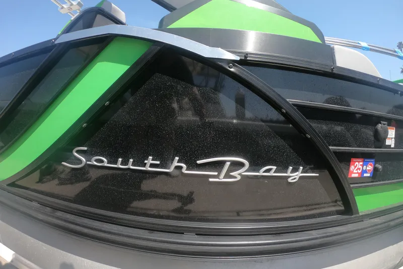 Slide: The Image of 2023 South Bay 525UL AR boat with sleek green and black design. - 25