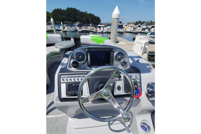 Slide: The Image of 2023 South Bay 525UL AR boat dashboard with steering wheel and navigation instruments. - 5