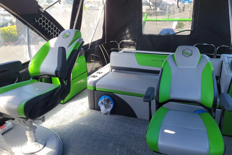Slide: The Image of Interior of 2023 South Bay 525UL AR boat with green and gray seating. - 8