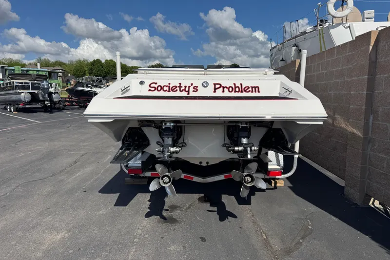 Slide: The Image of 2004 Fountain 35 Executioner boat named "Society's Problem" parked in a marina. - 2