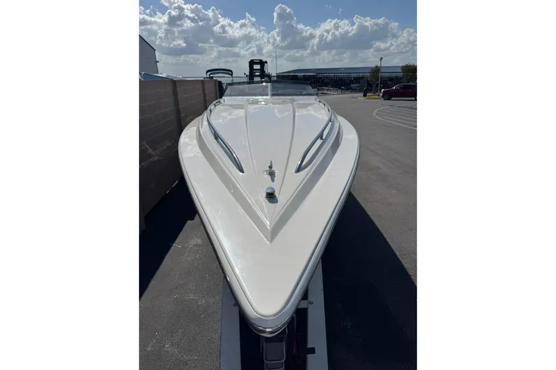 Slide: The Image of 2004 Fountain 35 Executioner speedboat with sleek white hull under a cloudy sky. - 4