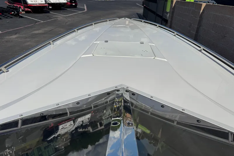 Slide: The Image of 2004 Fountain 35 Executioner boat bow, sleek design, parked in a lot. - 5