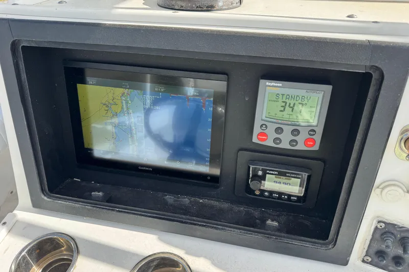 Slide: The Image of Control panel of a 2000 Regulator 26 Forward Seating boat with navigation and autopilot systems. - 11