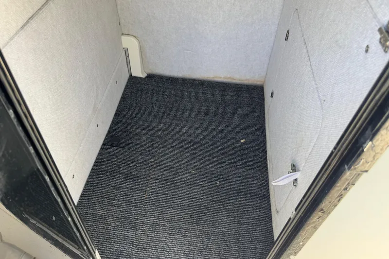 Slide: The Image of Interior cabin of a 2000 Regulator 26 Forward Seating boat with carpeted flooring. - 13