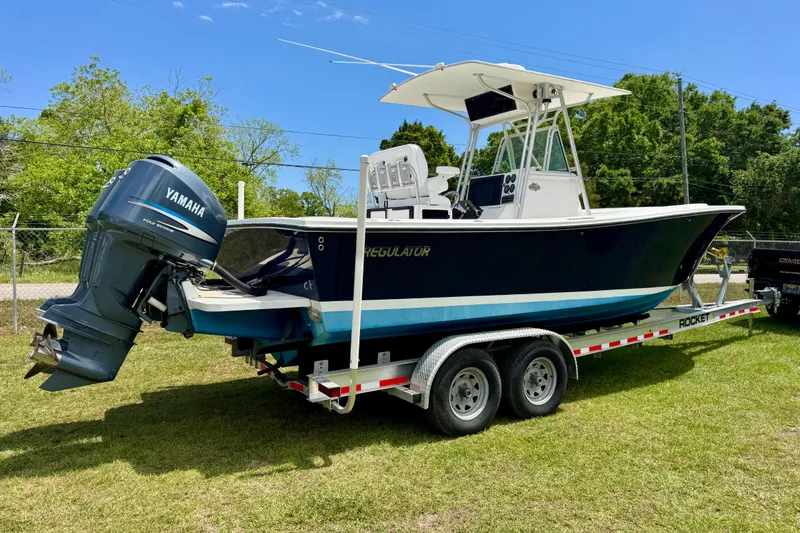Slide: The Image of 2000 Regulator 26 Forward Seating boat on trailer with Yamaha outboard motor. - 3