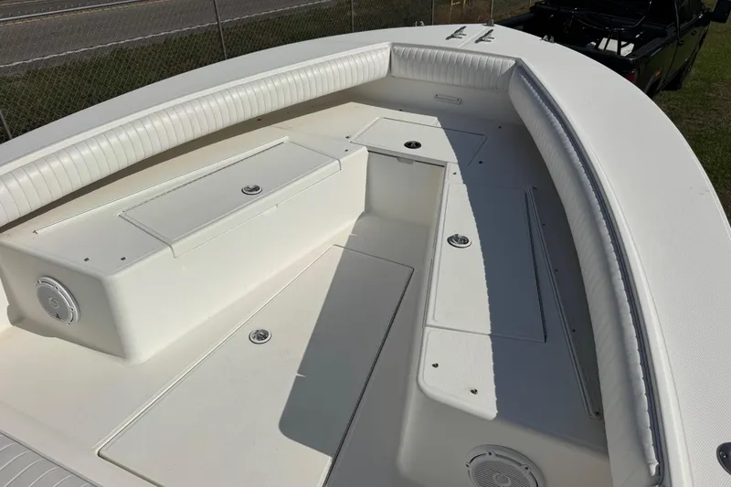 Slide: The Image of 2000 Regulator 26 Forward Seating boat with spacious white seating and storage compartments. - 5