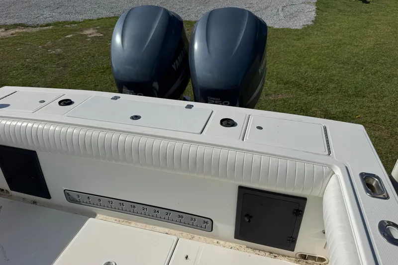 Slide: The Image of 2000 Regulator 26 Forward Seating boat with twin Yamaha engines, featuring a measuring scale. - 7