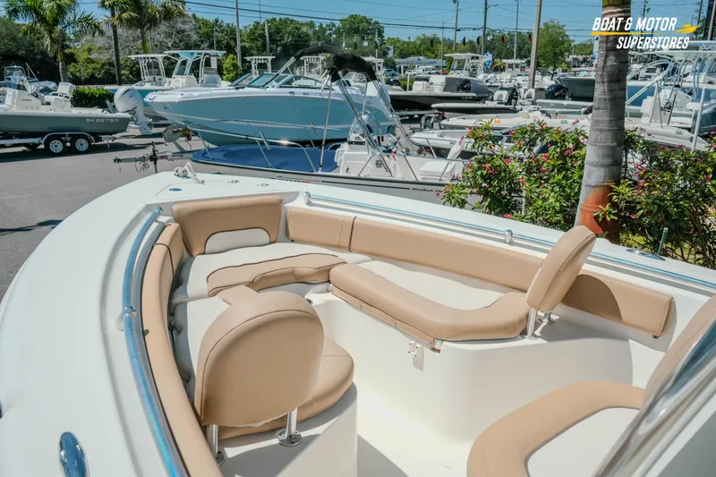 Slide: The Image of 2020 Key West 219 FS boat with tan seating, displayed at a dealership. - 12