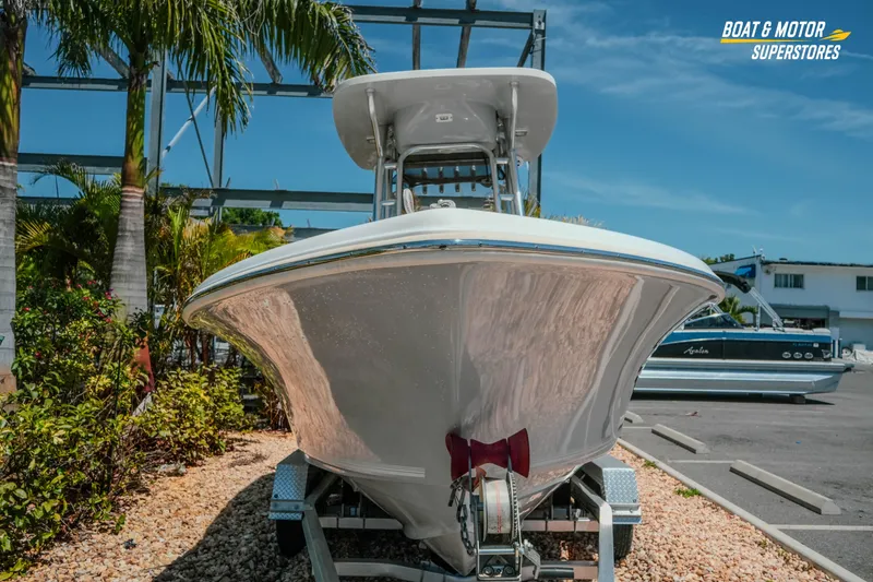 Slide: The Image of 2020 Key West 219 FS boat on trailer, surrounded by palm trees and clear sky. - 3