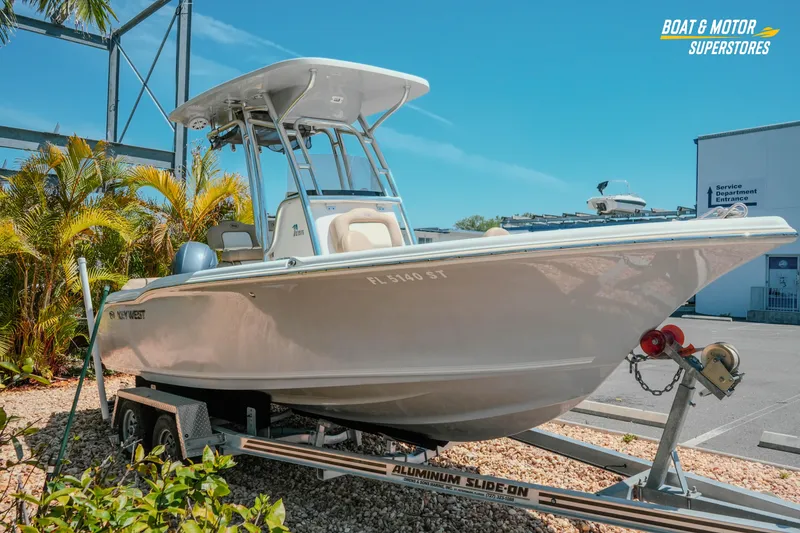 Slide: The Image of 2020 Key West 219 FS boat on trailer at dealership, sunny day. - 4