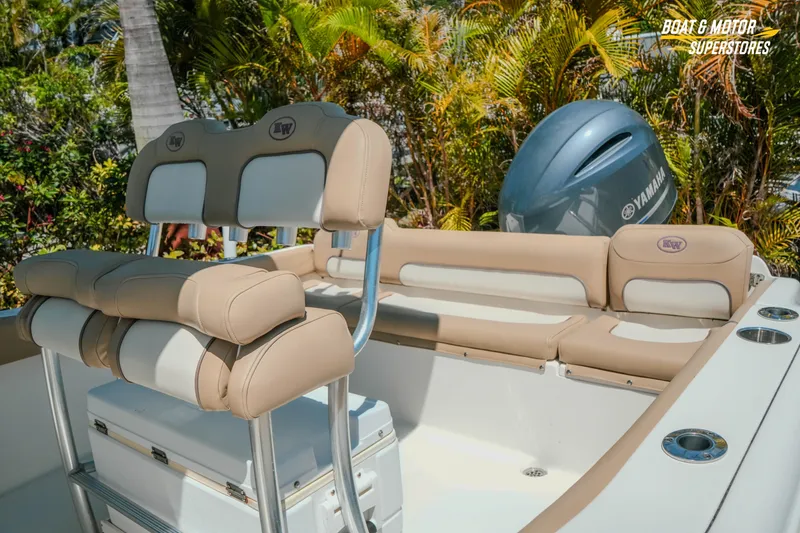 Slide: The Image of 2020 Key West 219 FS boat interior with Yamaha engine, featuring beige seating and lush greenery. - 9