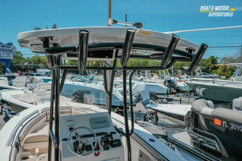 Slide: The Image of 2020 Sea Chaser 22 HFC boat at dealership, featuring helm and T-top. - 11