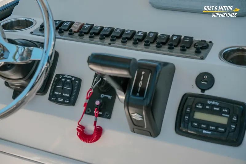Slide: The Image of Control panel of a 2020 Sea Chaser 22 HFC boat with steering wheel and switches. - 14