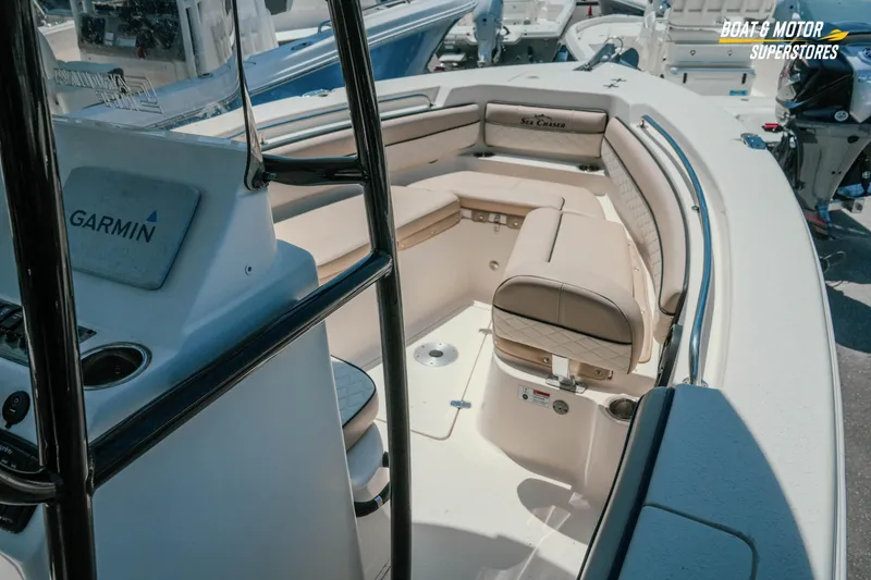 Slide: The Image of 2020 Sea Chaser 22 HFC boat interior with Garmin equipment, featuring beige seating. - 16
