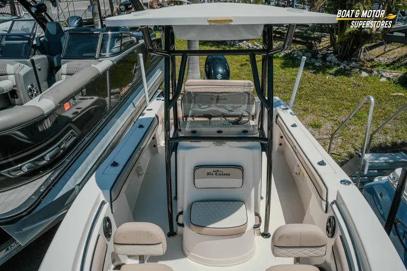 Slide: The Image of 2020 Sea Chaser 22 HFC boat interior with seating and console, displayed at dealership. - 19