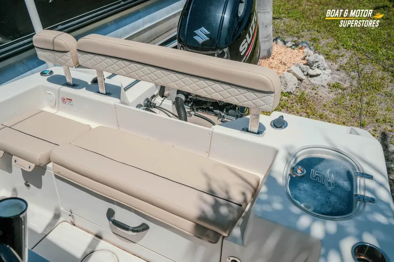 Slide: The Image of 2020 Sea Chaser 22 HFC boat interior with cushioned seating and Suzuki motor. - 25