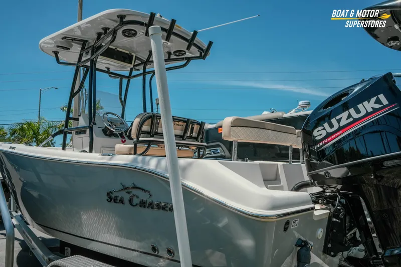 Slide: The Image of 2020 Sea Chaser 22 HFC boat with Suzuki engine, displayed outdoors. - 7