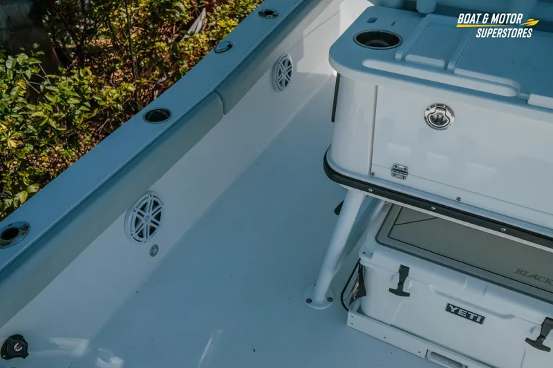 Slide: The Image of 2026 Blackfin 242 HB boat interior with Yeti cooler and storage features. - 13