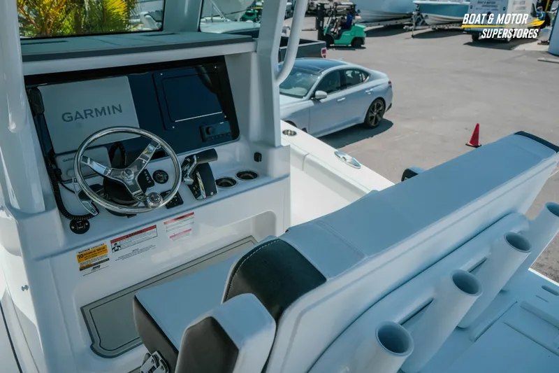 Slide: The Image of 2026 Blackfin 242 HB boat helm with Garmin navigation system and sleek seating. - 14
