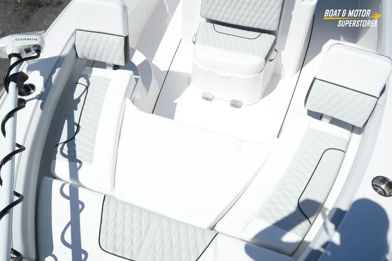 Slide: The Image of 2026 Blackfin 242 HB boat interior with cushioned seating and Garmin equipment. - 21