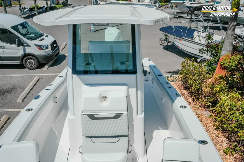 Slide: The Image of 2026 Blackfin 242 HB boat in parking lot, showcasing sleek design and modern features. - 23