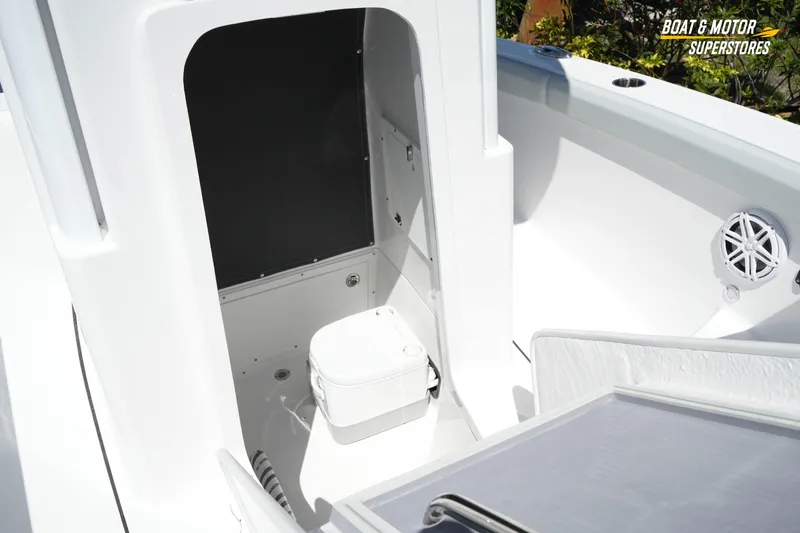Slide: The Image of 2026 Blackfin 242 HB boat interior with compact marine toilet and speaker system. - 24