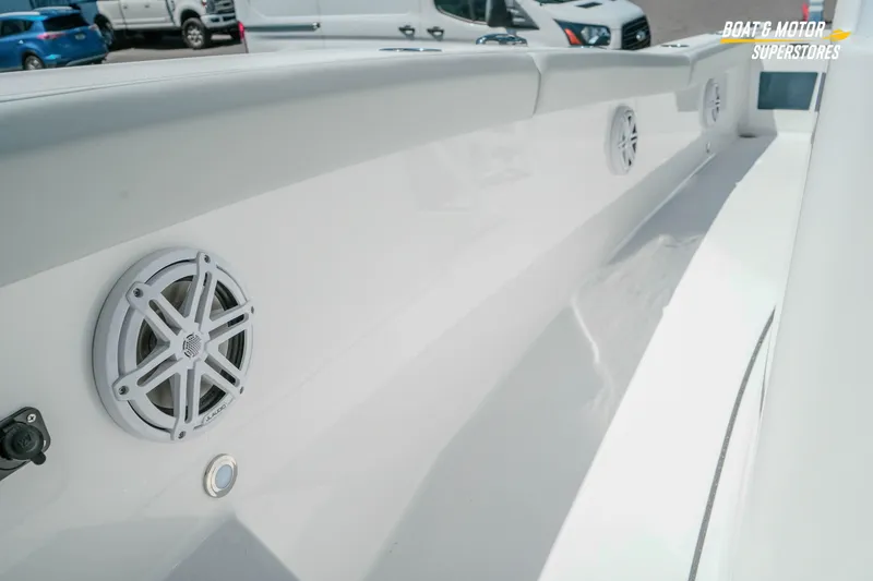 Slide: The Image of 2026 Blackfin 242 HB boat interior with speakers and sleek white design. - 26
