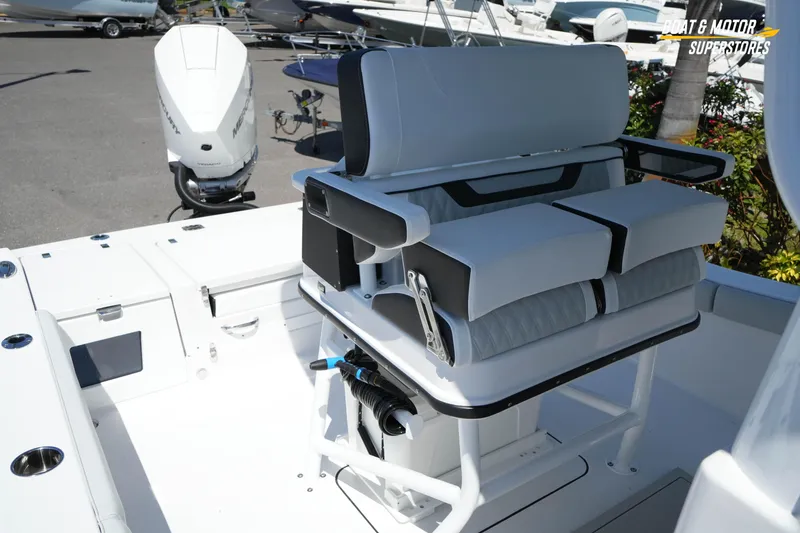 Slide: The Image of 2026 Blackfin 242 HB boat interior with cushioned seating and Mercury outboard motor. - 27