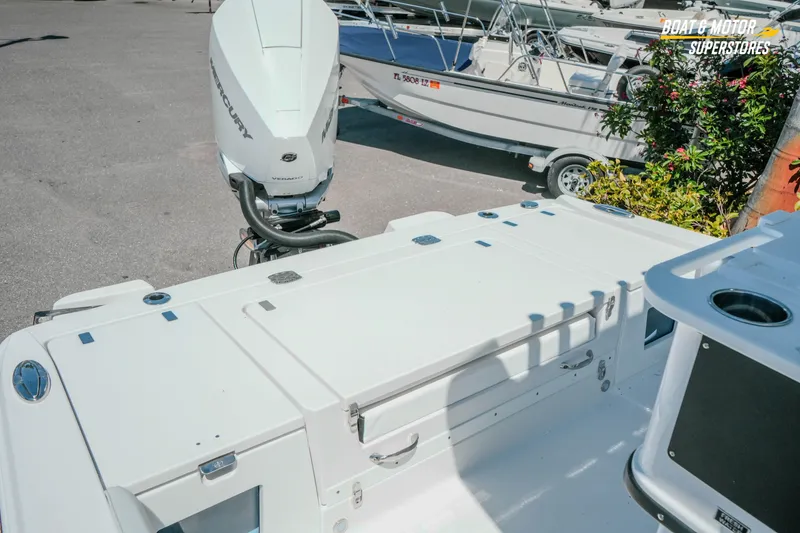 Slide: The Image of 2026 Blackfin 242 HB boat with Mercury engine, parked at a dealership. - 28