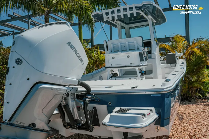 Slide: The Image of 2026 Blackfin 242 HB boat with Mercury engine, showcased outdoors amidst tropical plants. - 4