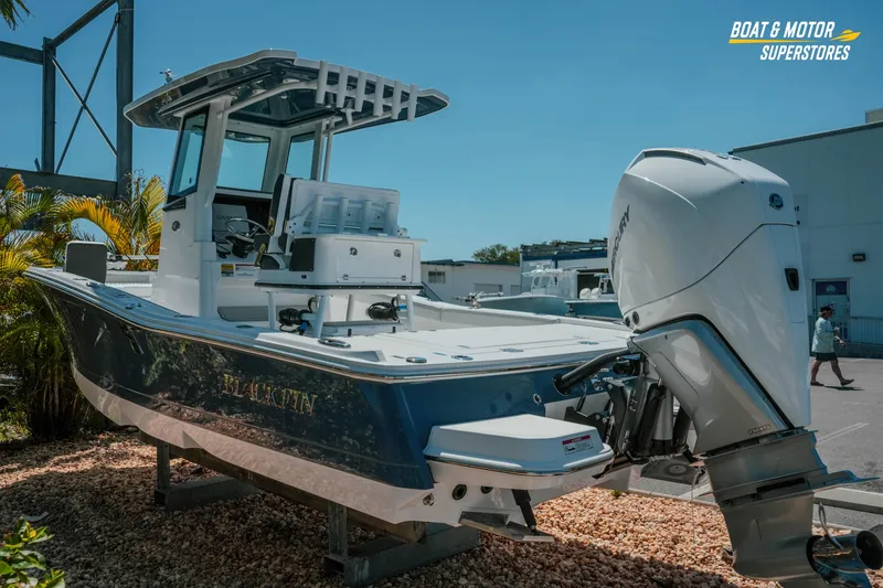 Slide: The Image of 2026 Blackfin 242 HB boat displayed outdoors with powerful outboard motor. - 6