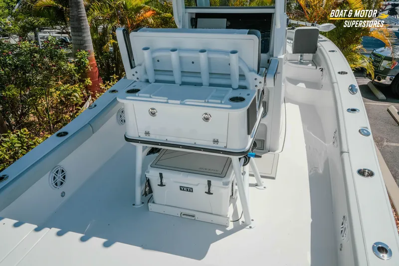 Slide: The Image of 2026 Blackfin 242 HB boat interior with coolers and rod holders. - 7