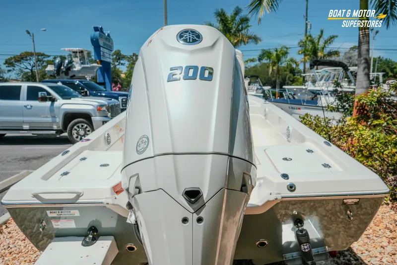 Slide: The Image of 2026 Skeeter SX221 boat with 200 HP engine at dealership, sunny day. - 10