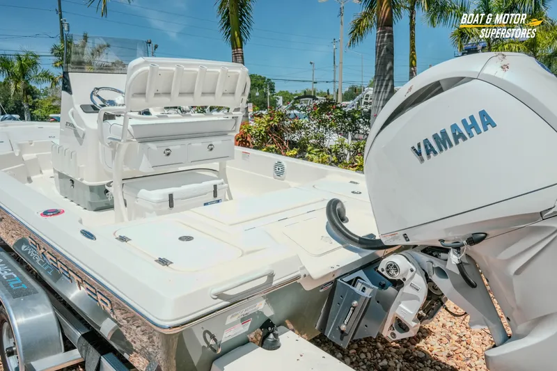 Slide: The Image of 2026 Skeeter SX221 boat with Yamaha motor, displayed outdoors with palm trees. - 11