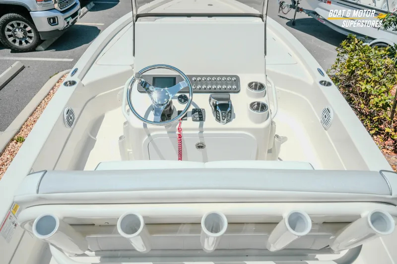 Slide: The Image of 2026 Skeeter SX221 boat console with steering wheel and controls in a parking lot. - 13