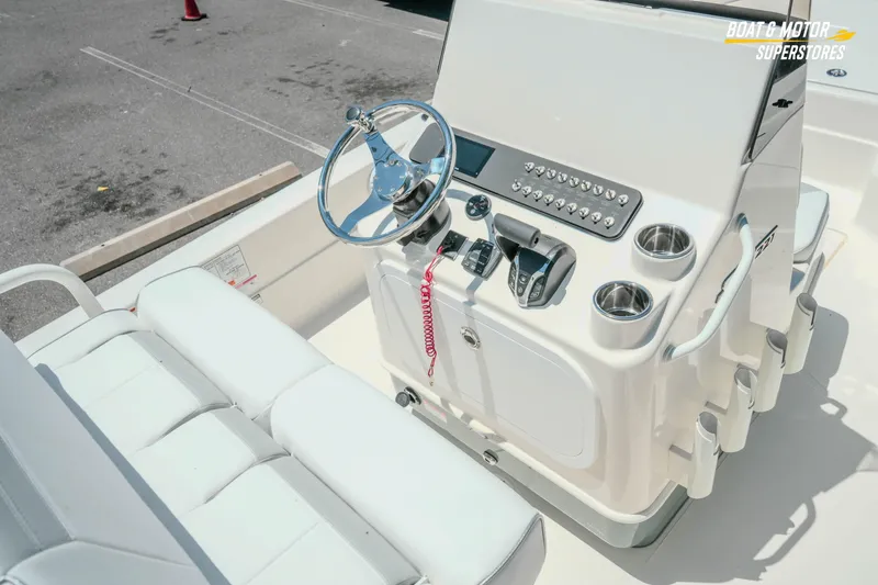 Slide: The Image of 2026 Skeeter SX221 boat console with steering wheel and controls in sunlight. - 15