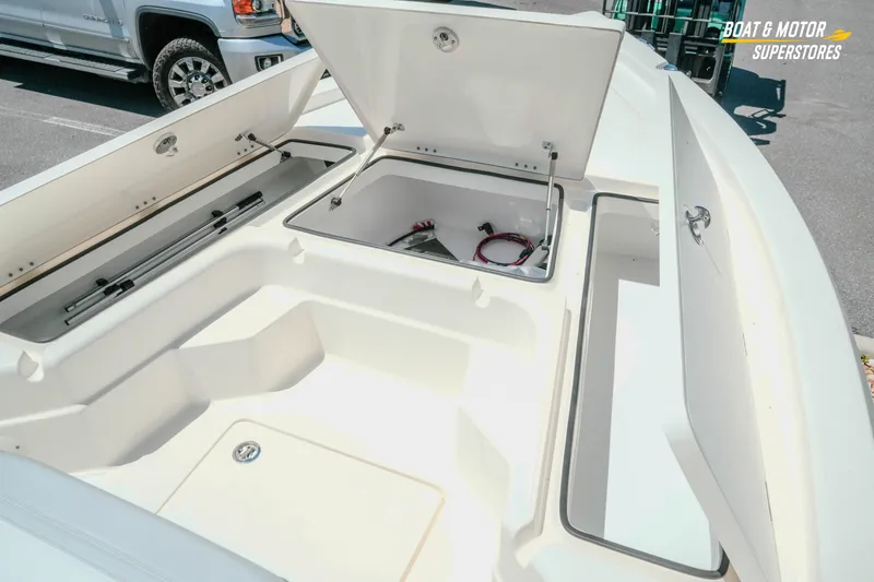 Slide: The Image of 2026 Skeeter SX221 boat storage compartments open, showcasing spacious interior design. - 18