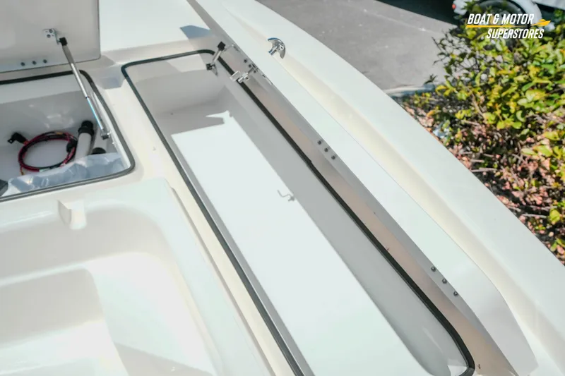 Slide: The Image of 2026 Skeeter SX221 boat storage compartments with open hatches, showcasing interior space. - 19
