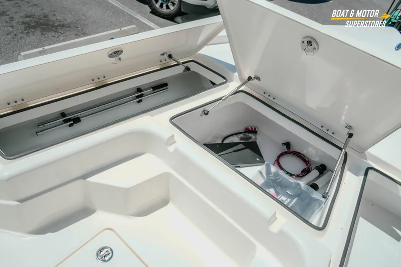 Slide: The Image of Open storage compartments on a 2026 Skeeter SX221 boat, showcasing ample space and equipment. - 20