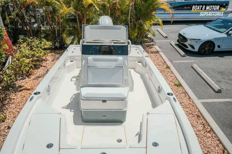 Slide: The Image of 2026 Skeeter SX221 boat displayed at dealership, surrounded by greenery and parked cars. - 22