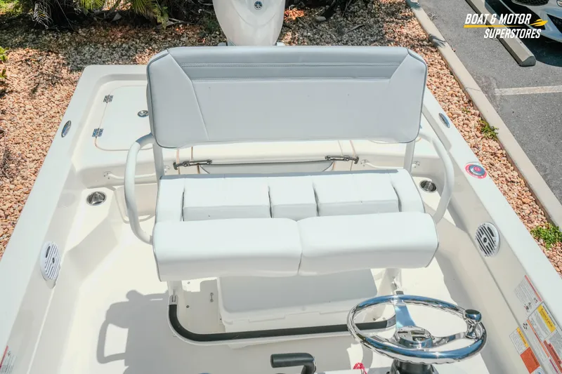 Slide: The Image of 2026 Skeeter SX221 boat interior with white seating and steering wheel. - 25