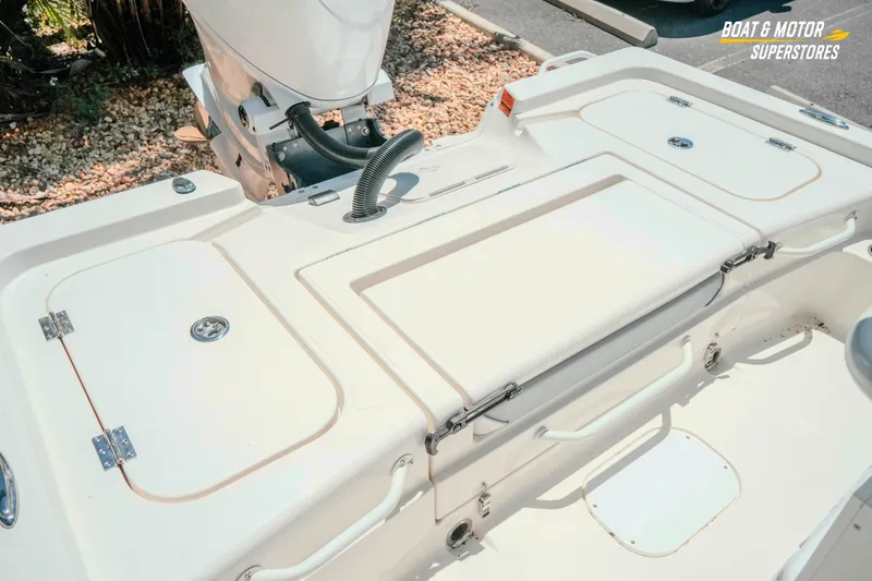 Slide: The Image of 2026 Skeeter SX221 boat deck with storage compartments and motor, at Boat & Motor Superstores. - 26