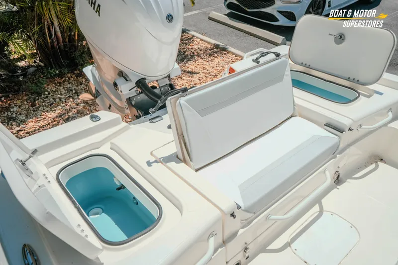 Slide: The Image of 2026 Skeeter SX221 boat interior with Yamaha engine, featuring seating and storage compartments. - 28