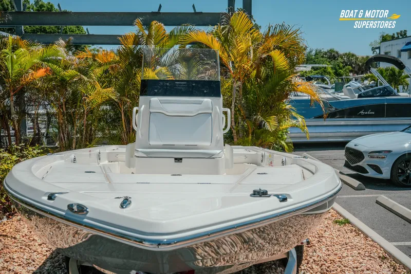 Slide: The Image of 2026 Skeeter SX221 boat displayed at dealership with tropical plants and parked vehicles. - 3
