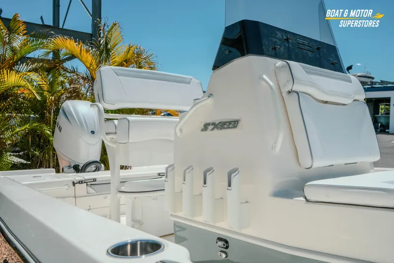 Slide: The Image of 2026 Skeeter SX221 boat interior with seating and Yamaha engine, showcased outdoors. - 5