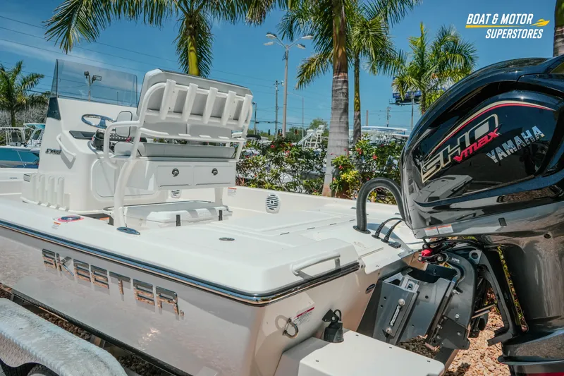 Slide: The Image of 2026 Skeeter SX221 boat with Yamaha engine, displayed outdoors with palm trees. - 10